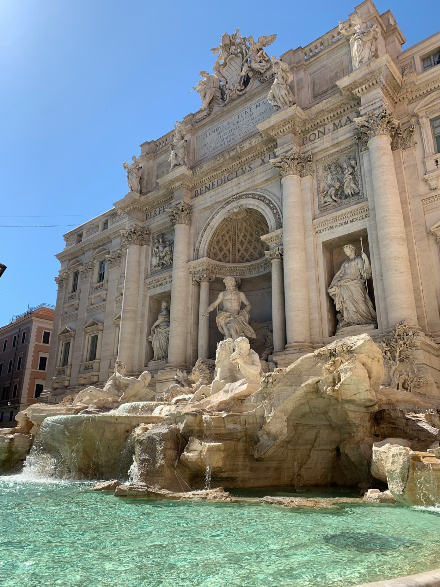 The Trevi Fountain in Rome under a blue sky