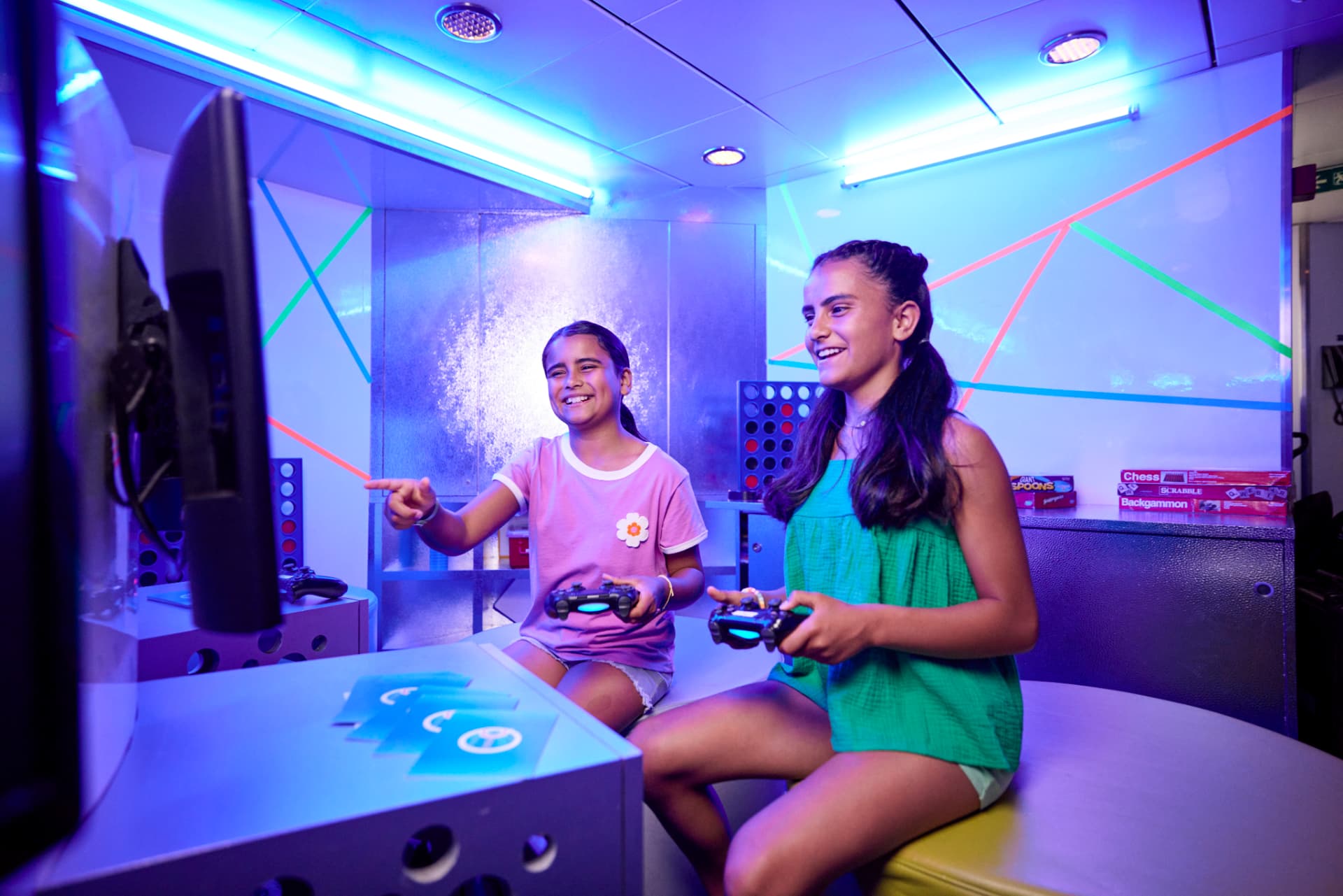Two girls playing video games in Carnival's Circle C youth club