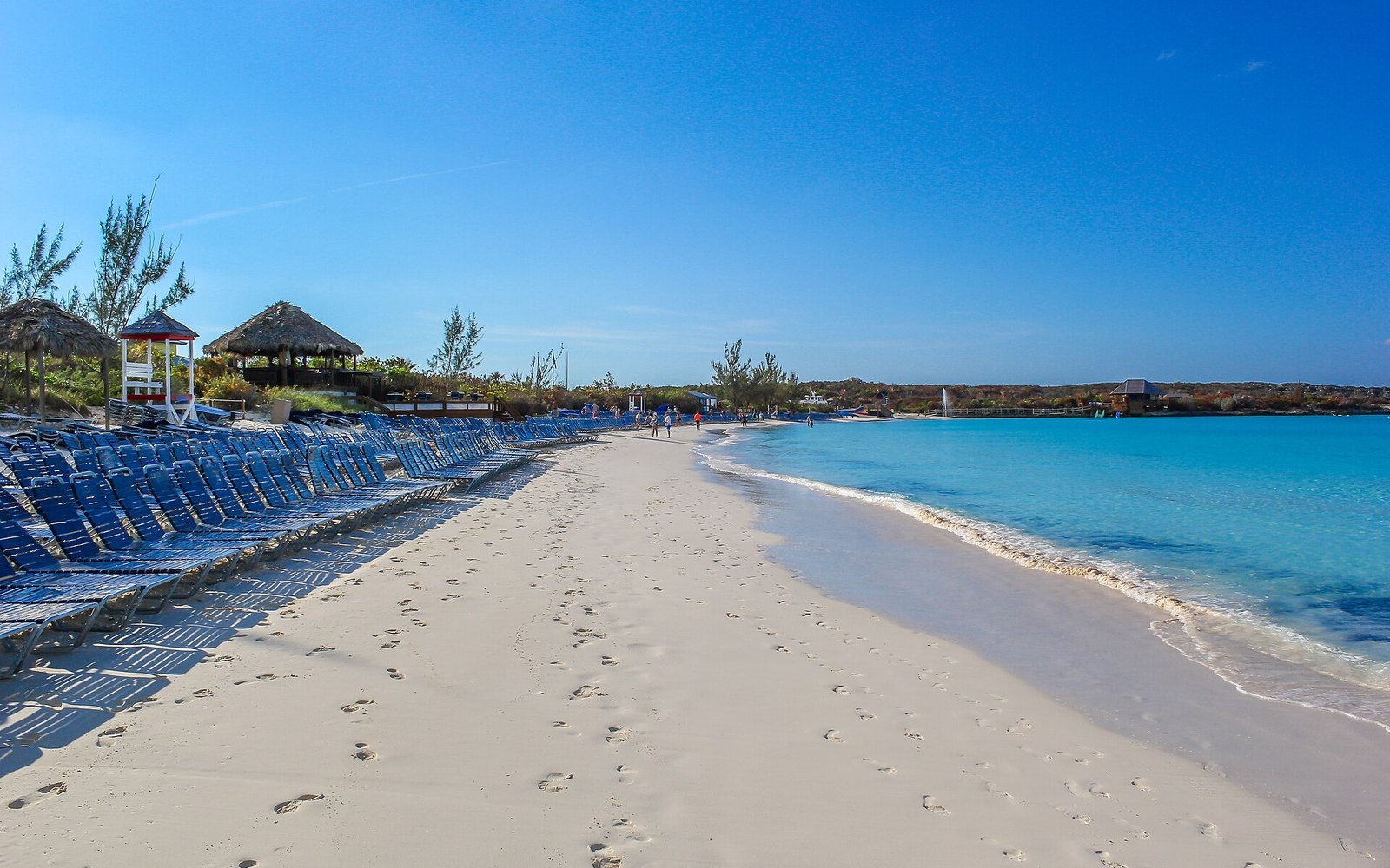 White sand beach, loungers and turquoise water at Half Moon Cay, Bahamas